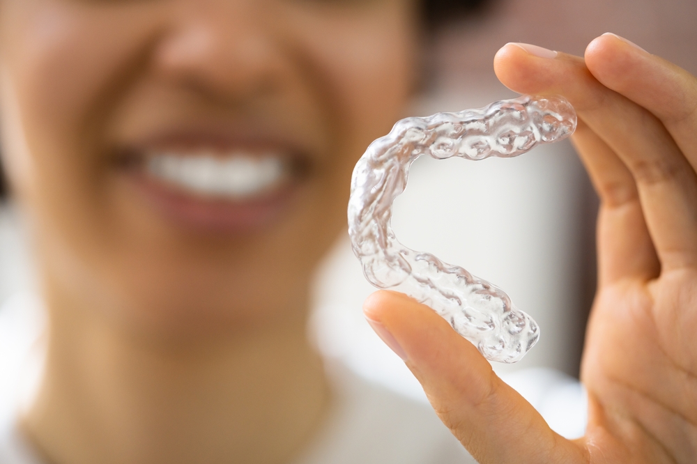 Woman holding an Invisalign in Orlando
